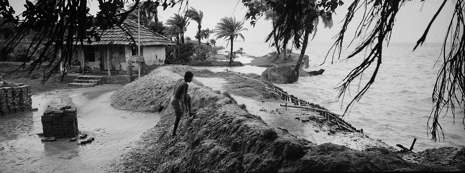 Photo by Jordi Pizarro. Ghoramara, India. A dyke is trying to protect the houses in the east of the Island.
