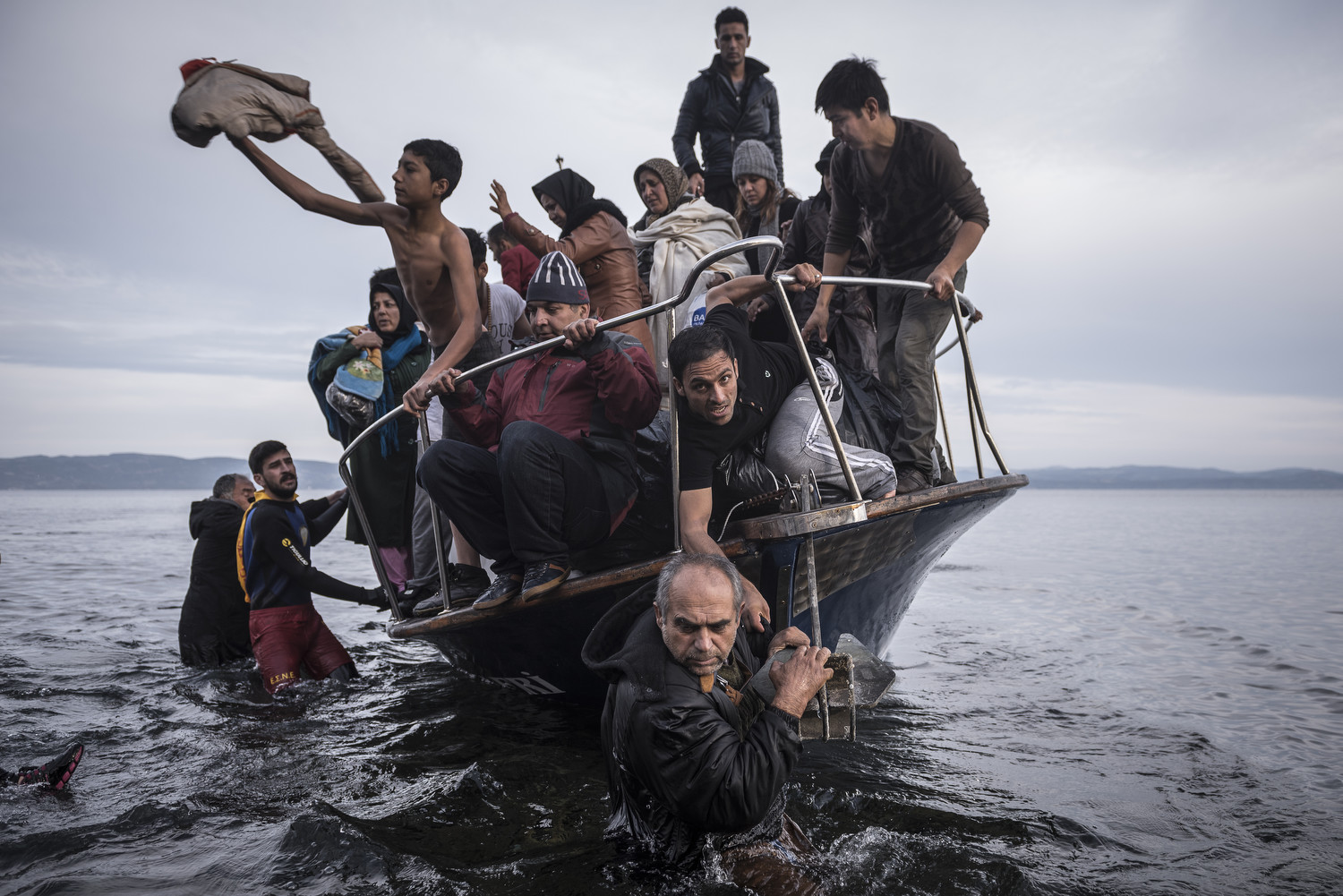 November 16, 2015. Refugees arrive by boat on the Greek island of Lesbos. This photo won first prize in the 2016 World Press Photo Awards for general news, stories. Photo by Sergey Ponomarev for the New York Times.