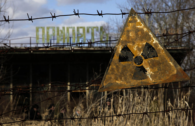 A radioactive sign hangs on barbed wire outside a café in Pripyat near Chernobyl where there was a nuclear disaster in 1986.  D. Markosian: One Day in the Life of Chernobyl, VOA News, photo gallery.  Image in public domain.