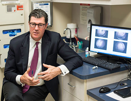Dr. Michael Maloney ’97M (Res), an orthopedic surgeon and sports medicine specialist at the University of Rochester Medical Center, meets with patients at his Clinton Crossing office 