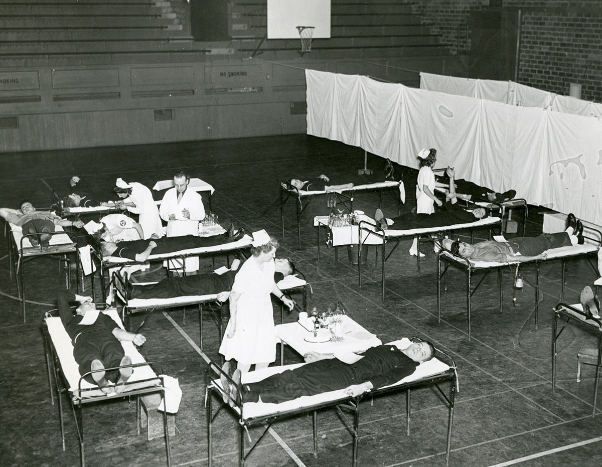 Students participate in a blood drive in the Palestra. (University photo / Rare Books, Special Collections, and Preservation)