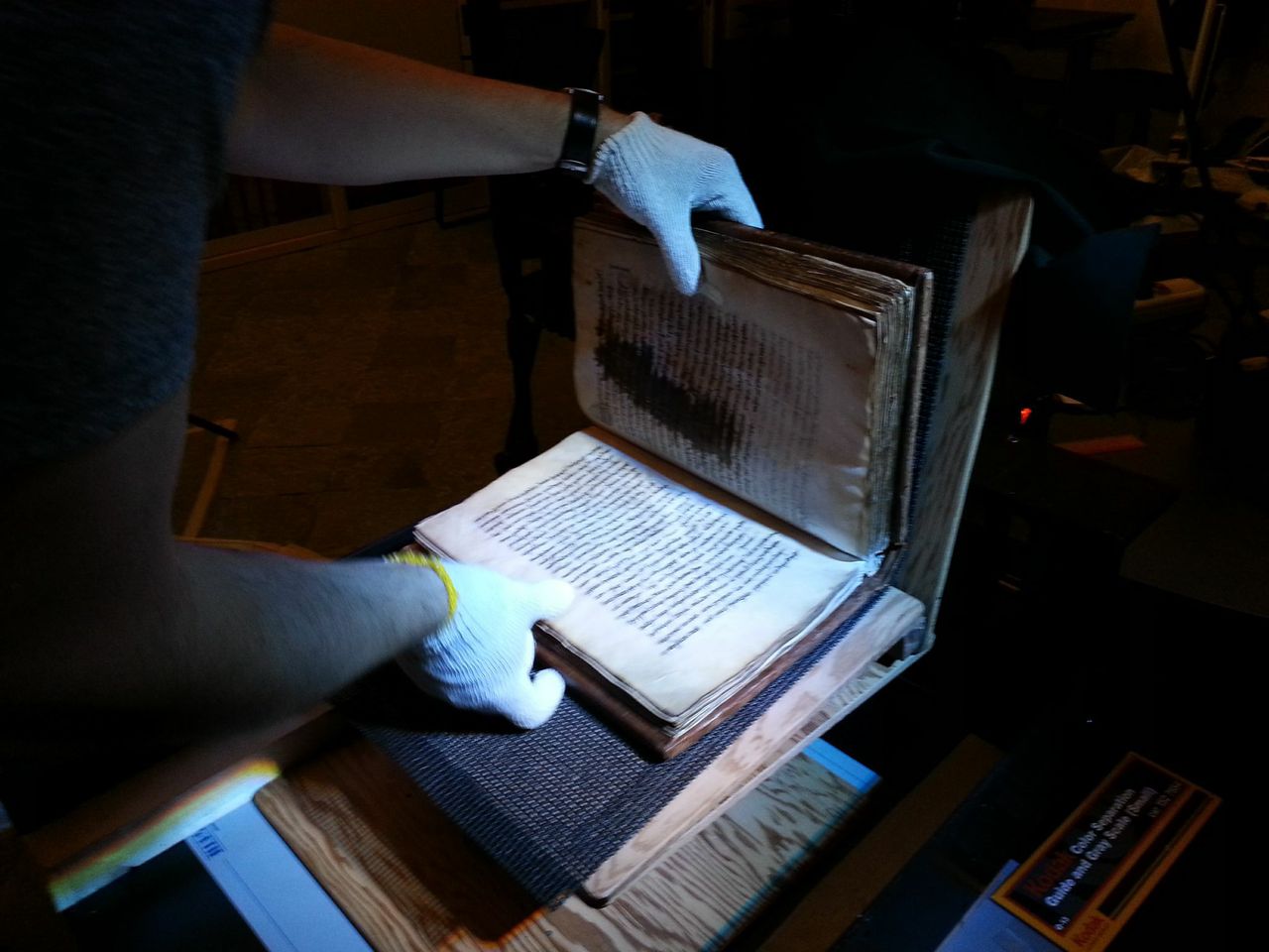 CAUTIONARY MEASURES: The manuscripts and codexes require careful handling. (University photo / J. Adam Fenster)
