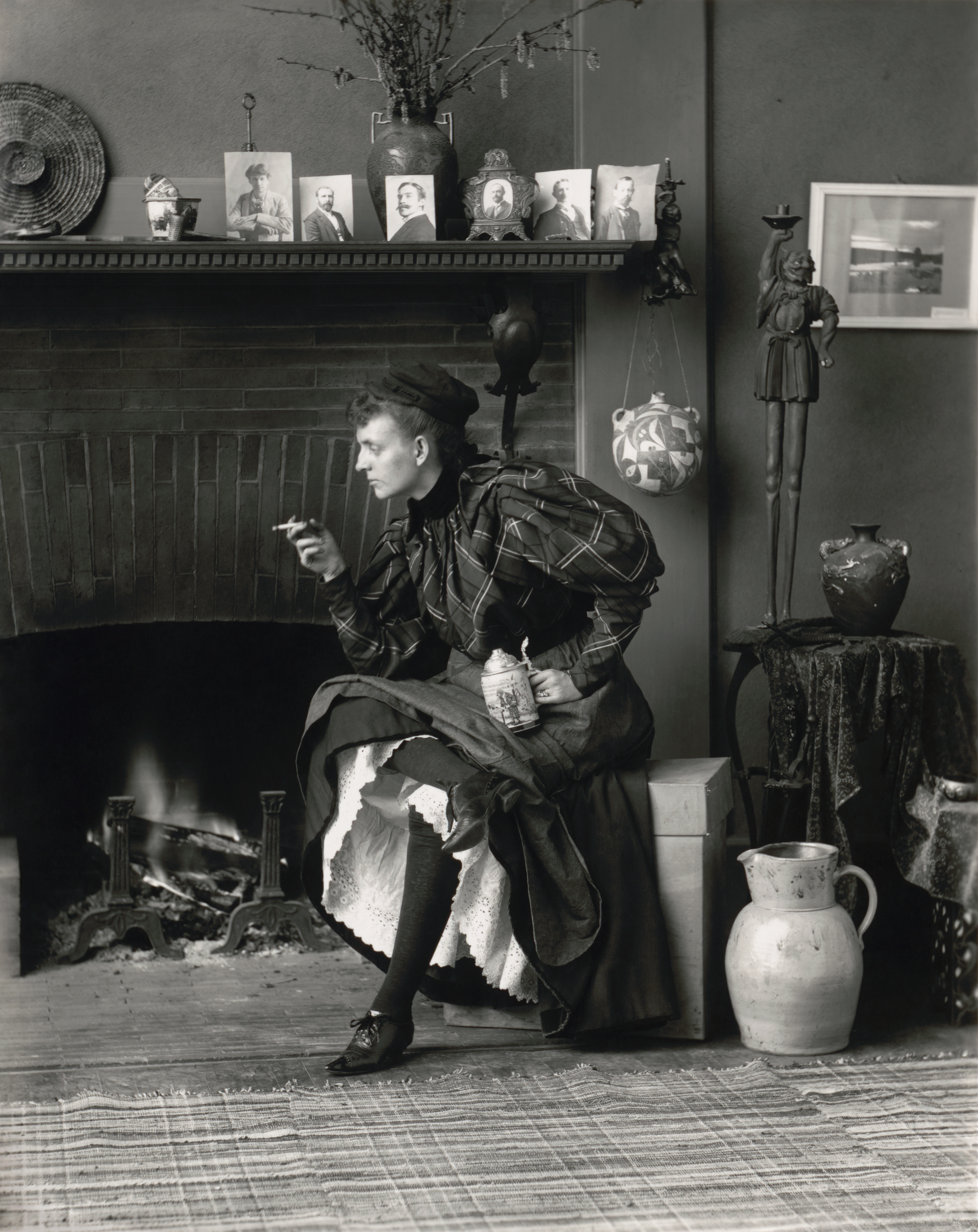 Frances Benjamin Johnston’s “New Woman,” a full-length self-portrait holding a cigarette in one hand and a beer stein in the other, in her Washington, D.C. studio. Library of Congress.