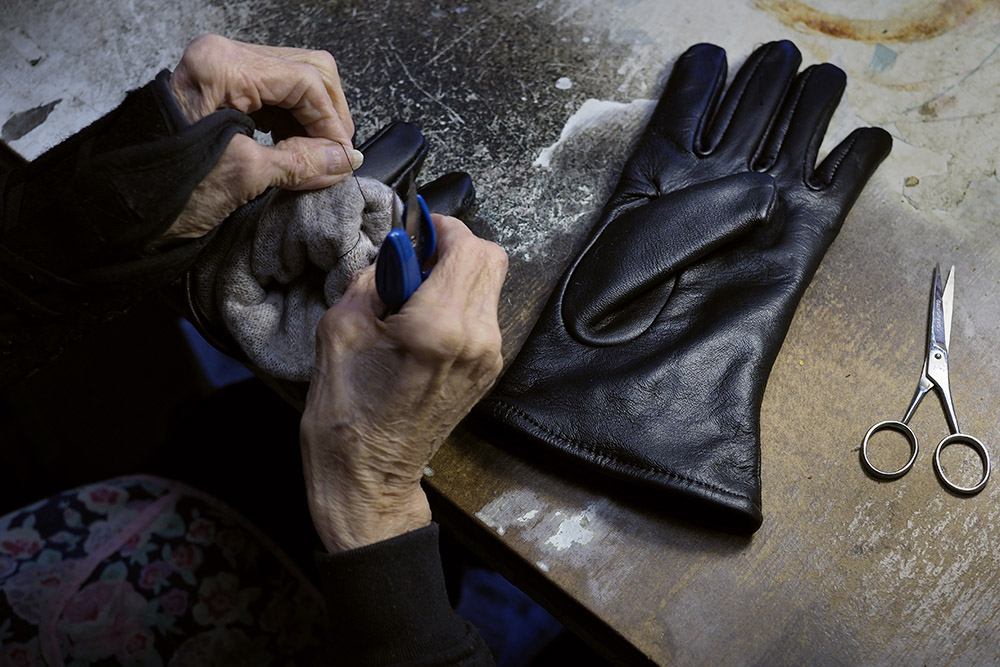 91-year-old Blanche Mecucci works as a product inspector at Samco, the only remaining glove factory in Gloversville. Samco began making gloves in 1996 after moving into an old glove factory at 122 S. Main Street. The company specializes in contract work for the U.S. Military. Image by Larry C. Price. United States, 2016.