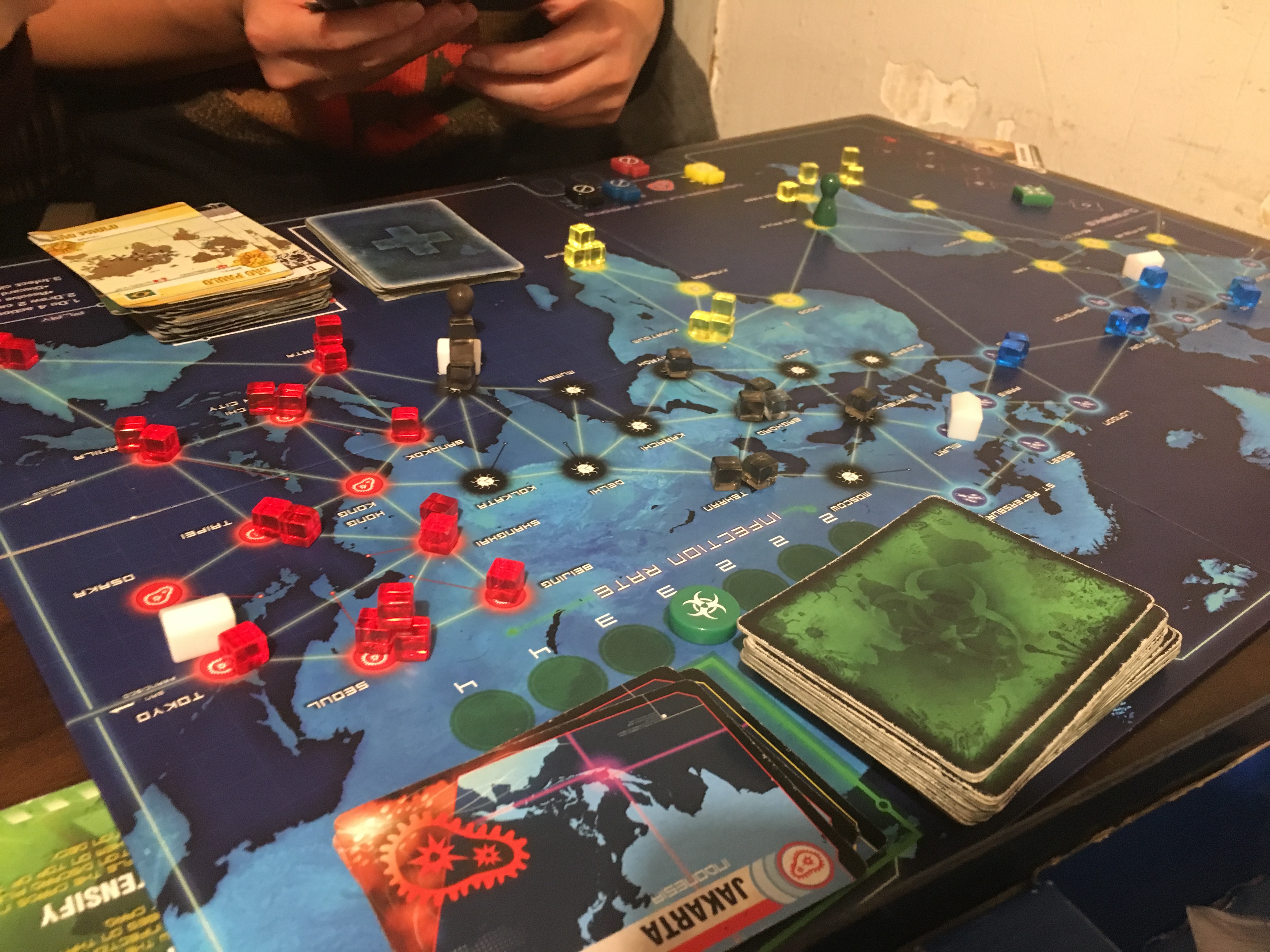 The game 'Pandemic' in progress. Designed by Matt Leacock, this game pits players against the board as they race to cure the world of several deadly diseases.