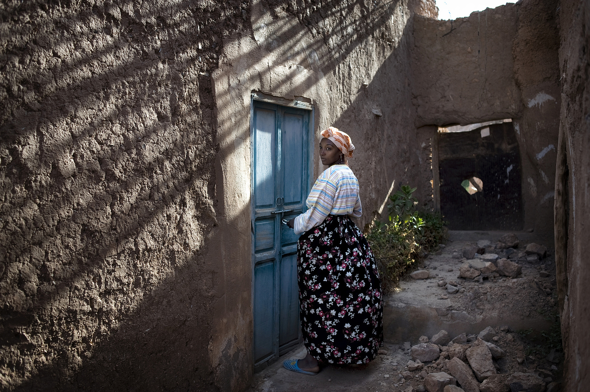 Zubeida, 28, opens the door to the Synagogue which she has been the guardian of since its restoration in 2002 in the small southern Village of Irill Noro, Morocco. (Photo: Aaron Vincent Elkaim)
